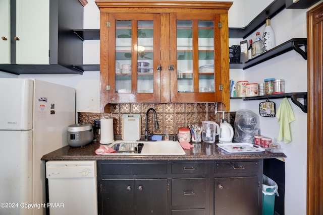 kitchen with open shelves, tasteful backsplash, glass insert cabinets, a sink, and white appliances