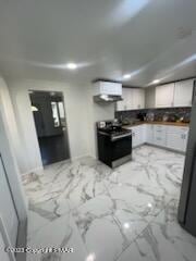 kitchen featuring white cabinetry, marble finish floor, and electric range oven