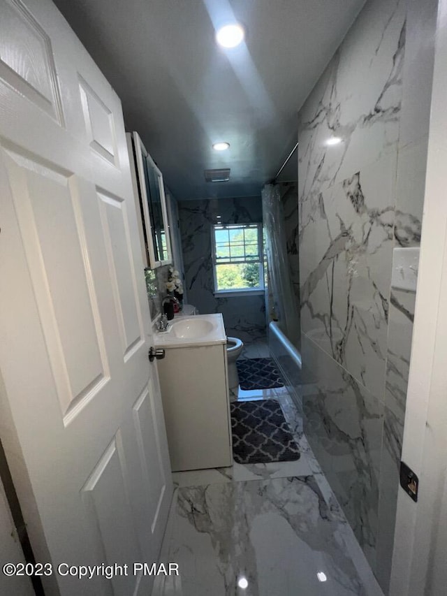 full bathroom featuring vanity, stone wall, a marble finish shower, toilet, and marble finish floor