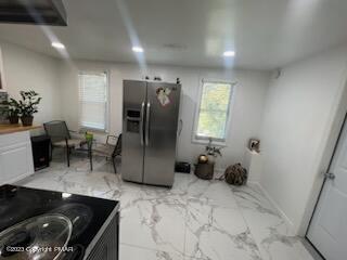 kitchen featuring range with electric cooktop, marble finish floor, stainless steel refrigerator with ice dispenser, recessed lighting, and baseboards