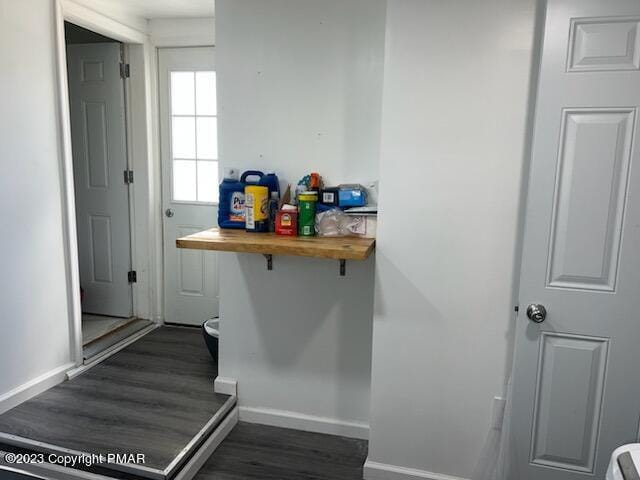 stairs featuring wood finished floors and baseboards