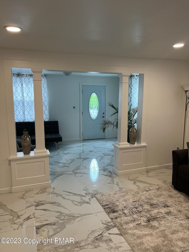 foyer entrance featuring recessed lighting, decorative columns, baseboards, and marble finish floor