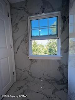 miscellaneous room featuring marble finish floor