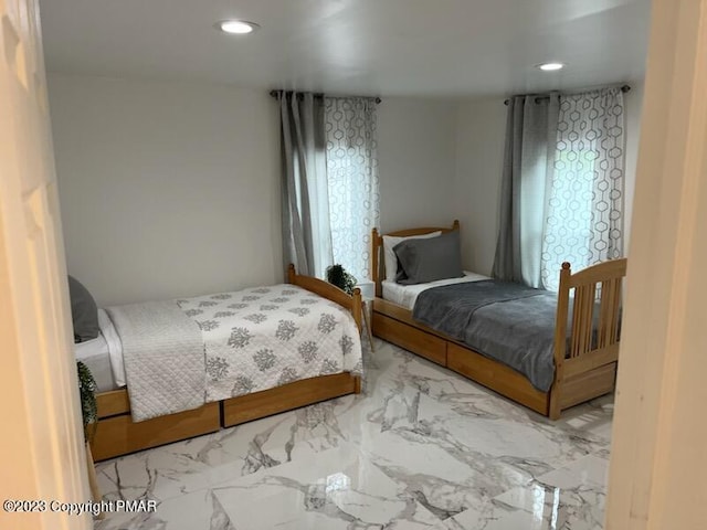 bedroom featuring recessed lighting and marble finish floor