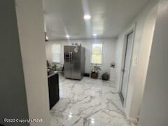 kitchen with stainless steel fridge and marble finish floor