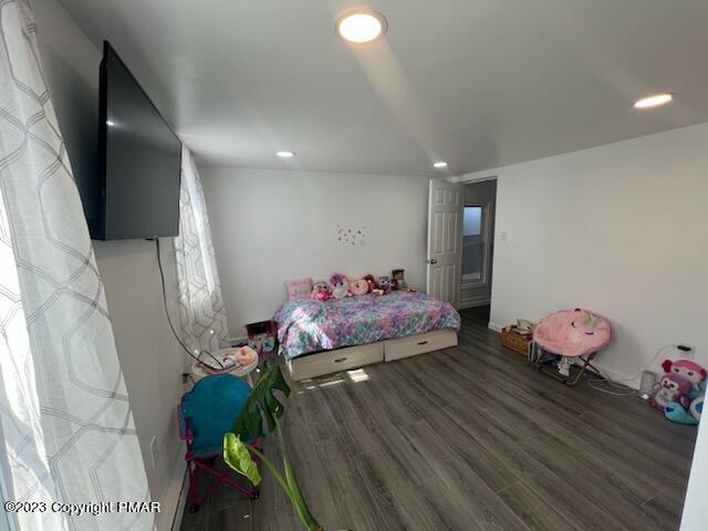 bedroom with recessed lighting and wood finished floors