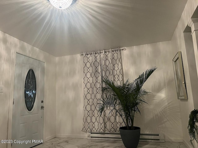 foyer with a baseboard heating unit, baseboards, and marble finish floor