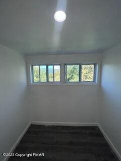 unfurnished room with baseboards