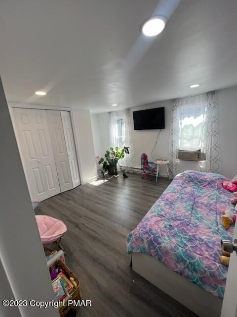 bedroom featuring a closet, recessed lighting, and wood finished floors