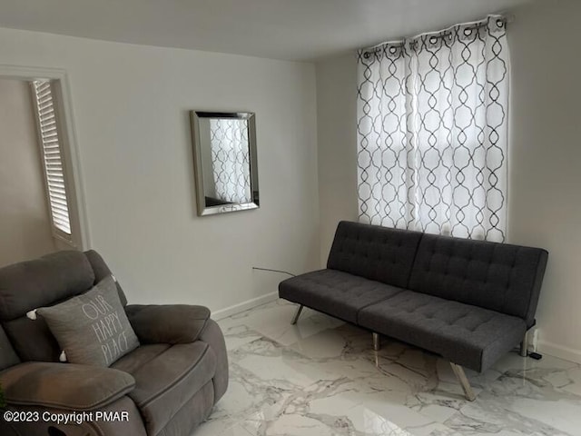 living room featuring marble finish floor and baseboards