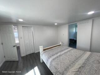 bedroom with recessed lighting and wood finished floors