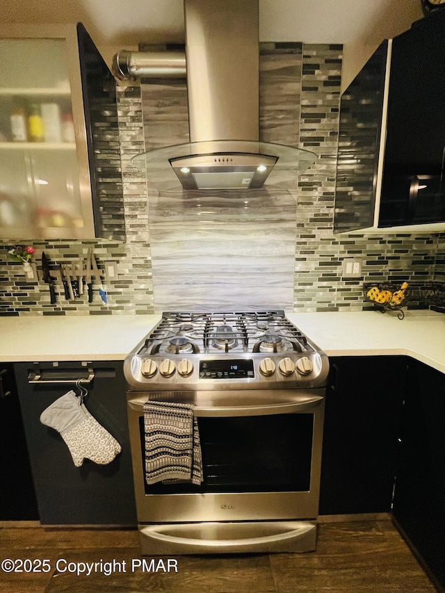 kitchen featuring light countertops, tasteful backsplash, island exhaust hood, and stainless steel range with gas stovetop