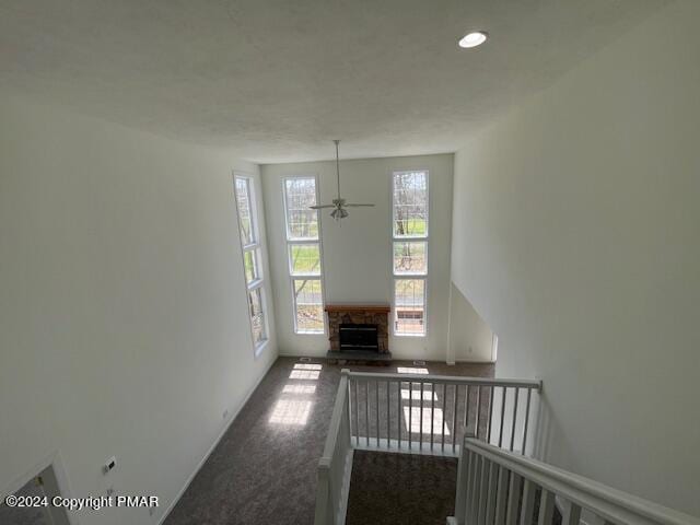 unfurnished living room featuring recessed lighting and a fireplace with raised hearth