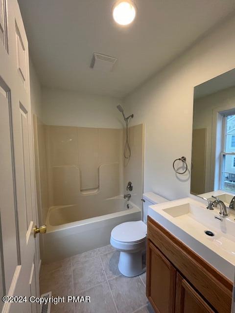 bathroom featuring toilet, visible vents, tub / shower combination, and vanity