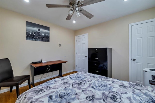 bedroom featuring ceiling fan, baseboards, and wood finished floors