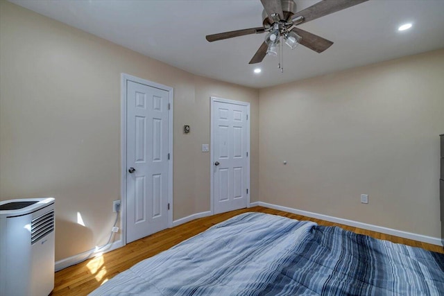 bedroom with recessed lighting, wood finished floors, baseboards, and ceiling fan