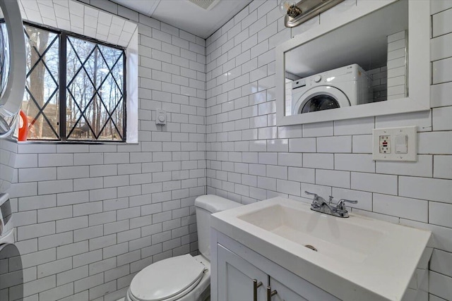 bathroom featuring backsplash, toilet, tile walls, and vanity