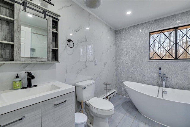 bathroom featuring vanity, a freestanding tub, ornamental molding, tile walls, and toilet