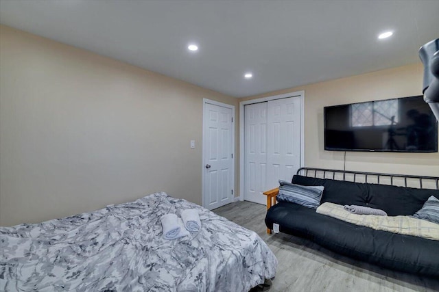 bedroom featuring a closet, recessed lighting, and wood finished floors