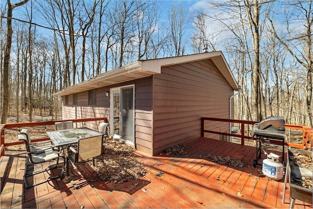 wooden terrace with outdoor dining area