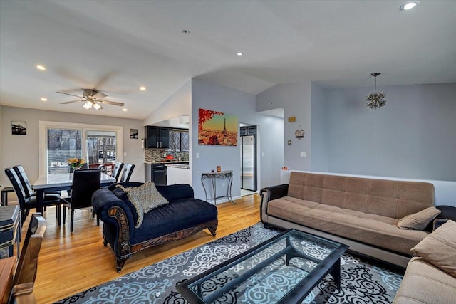 living room featuring recessed lighting, light wood-style flooring, a ceiling fan, and vaulted ceiling