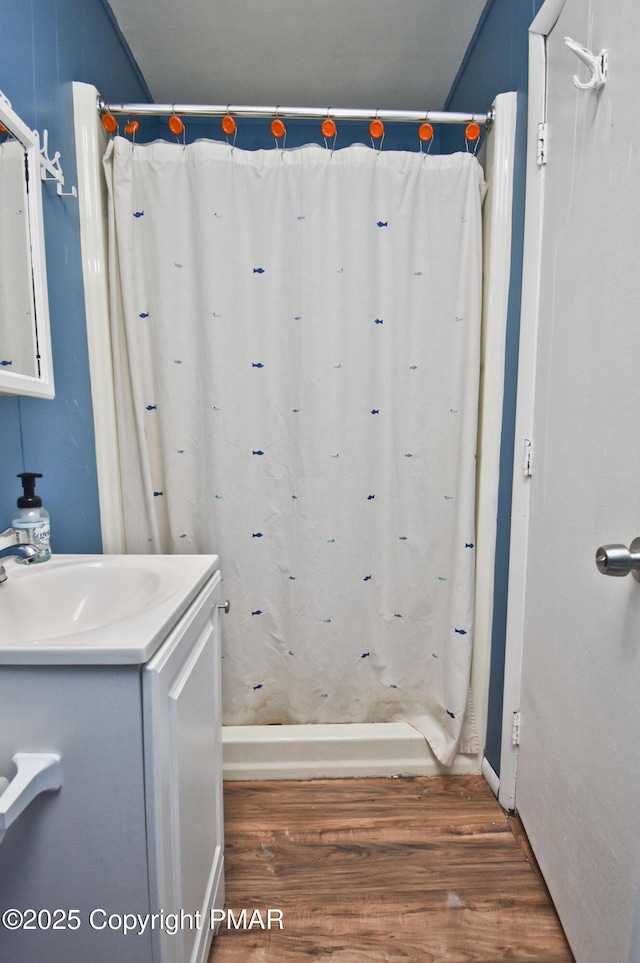 full bath featuring a shower with curtain, wood finished floors, and vanity