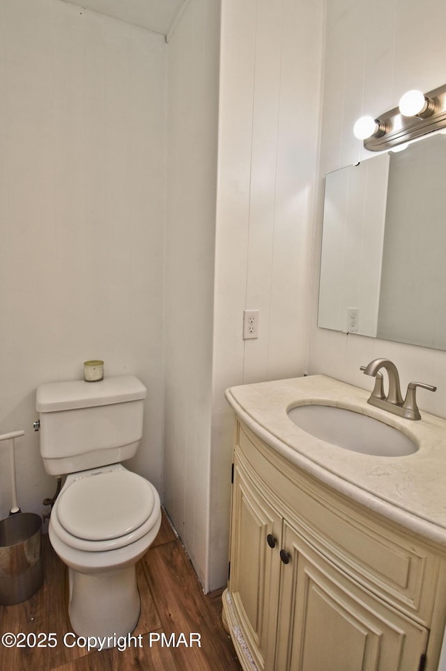 bathroom featuring vanity, toilet, and wood finished floors