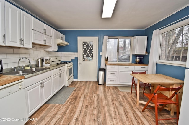 kitchen featuring white appliances, a sink, and white cabinets