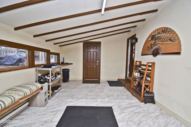 foyer entrance with marble finish floor, vaulted ceiling with beams, and baseboards