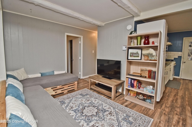 living room with beamed ceiling and wood finished floors