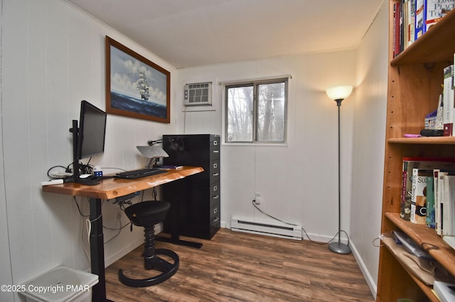 office space featuring an AC wall unit, dark wood-style flooring, a baseboard radiator, and baseboards