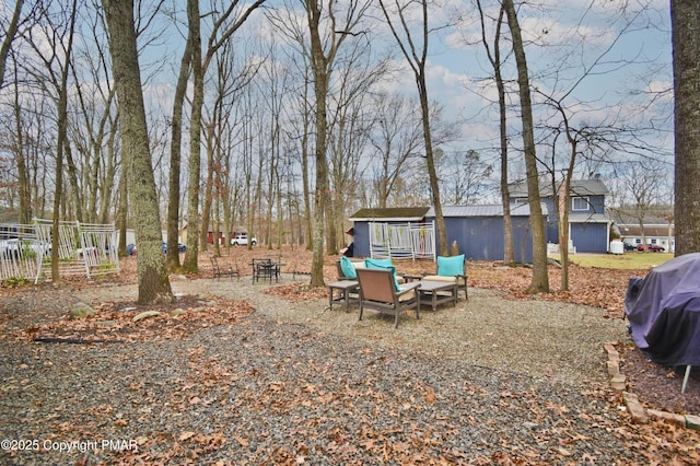 view of yard featuring an outbuilding and fence