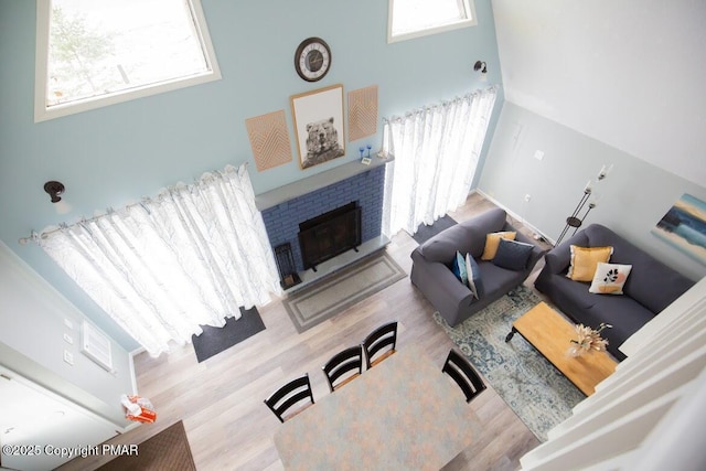 living area with a fireplace and wood finished floors