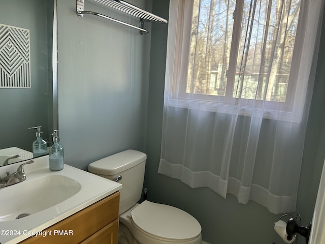 bathroom with toilet and vanity