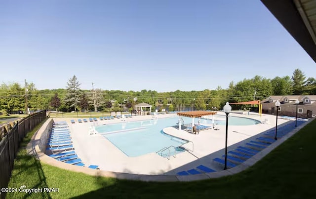 pool featuring fence and a patio