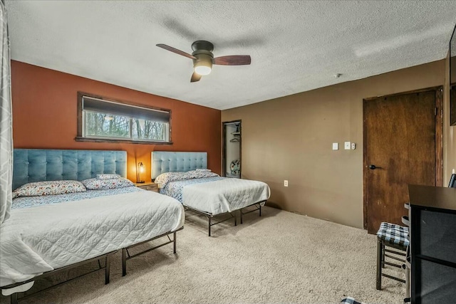 bedroom with carpet floors, ceiling fan, and a textured ceiling