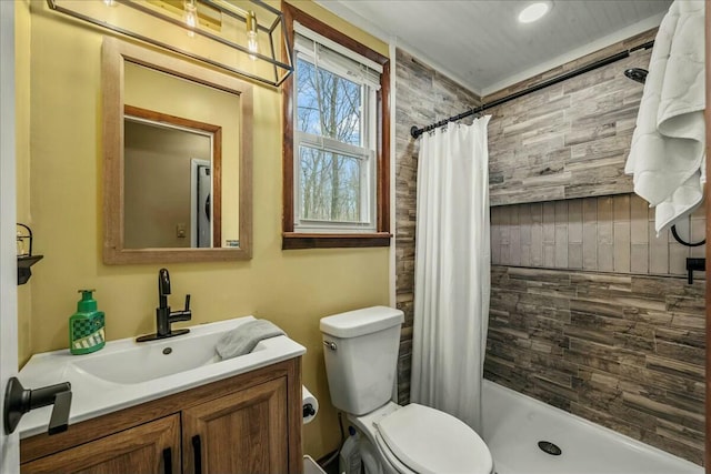 bathroom featuring a tile shower, vanity, and toilet