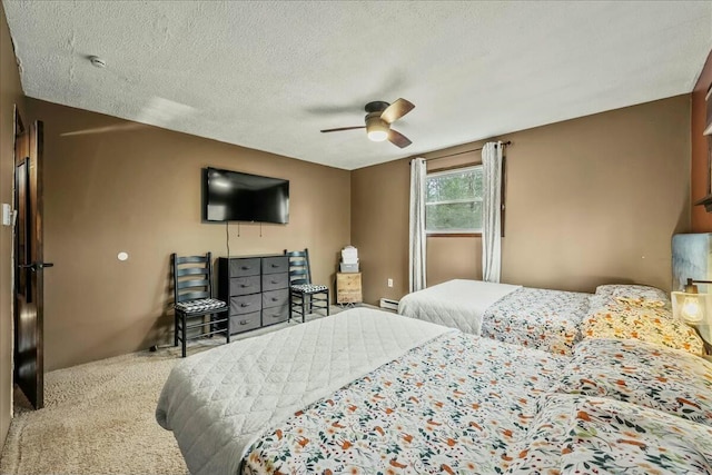 bedroom featuring ceiling fan, a textured ceiling, baseboard heating, and carpet flooring