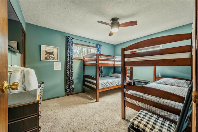 bedroom featuring a textured ceiling, carpet floors, a ceiling fan, and baseboards