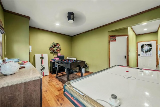 playroom featuring crown molding and light wood finished floors