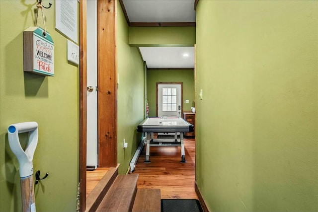 hallway featuring wood finished floors and baseboards