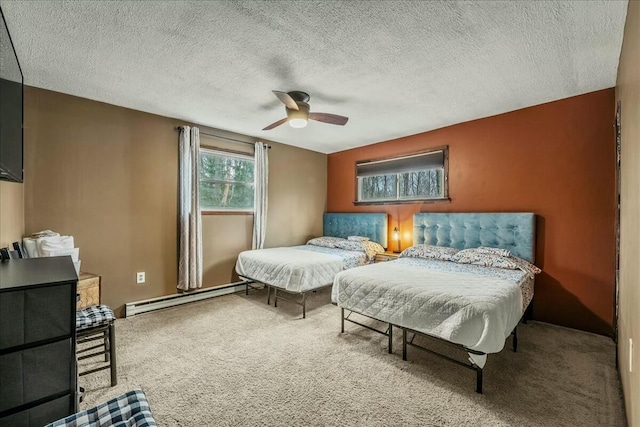 bedroom featuring a textured ceiling, carpet floors, baseboard heating, and a ceiling fan