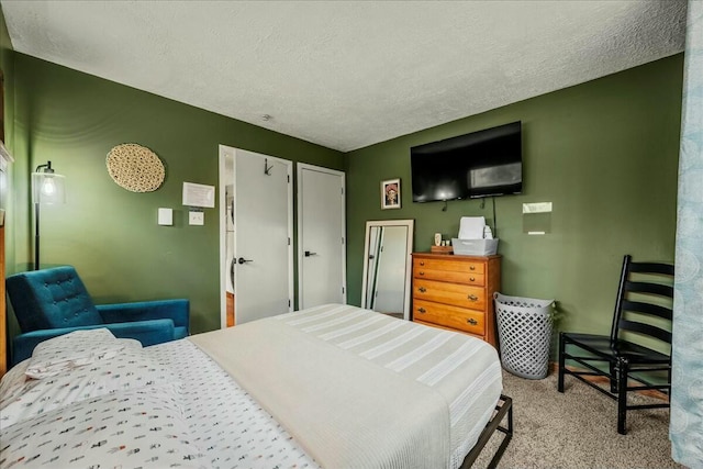 carpeted bedroom featuring a textured ceiling