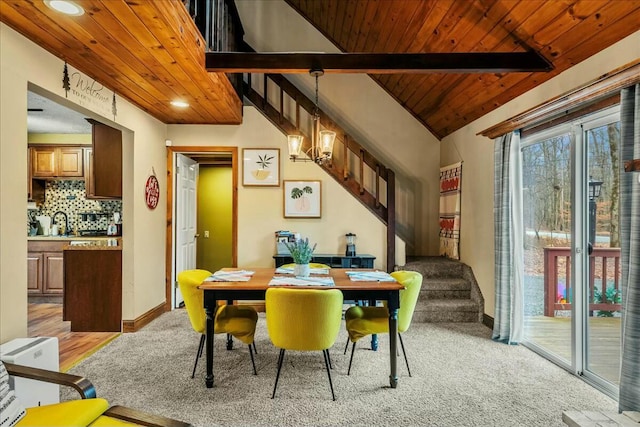 dining room with recessed lighting, lofted ceiling with beams, wood ceiling, baseboards, and stairs