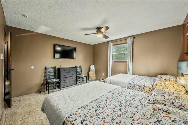 carpeted bedroom featuring a ceiling fan, a baseboard radiator, and a textured ceiling