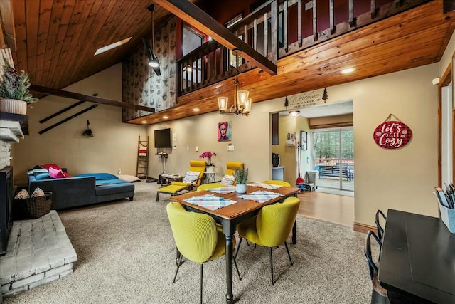 dining space with high vaulted ceiling, a stone fireplace, wood ceiling, carpet, and an inviting chandelier