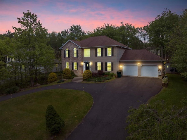 3336 Buck Run, Tobyhanna, PA 18466 - colonial home with driveway, an attached garage, a front lawn, and view of wooded area