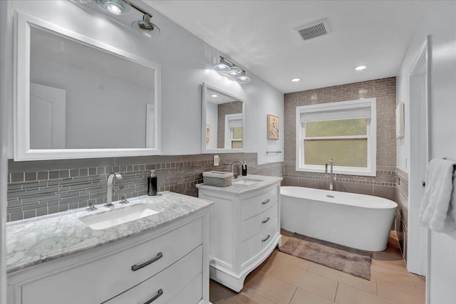 3336 Buck Run, Tobyhanna, PA 18466 - bathroom featuring tile walls, two vanities, a freestanding bath, tile patterned floors, and a wainscoted wall