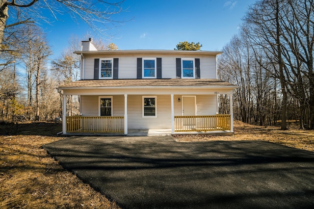 663 Sullivan Trl, Long Pond, PA 18334 - view of front facade featuring a chimney and covered porch