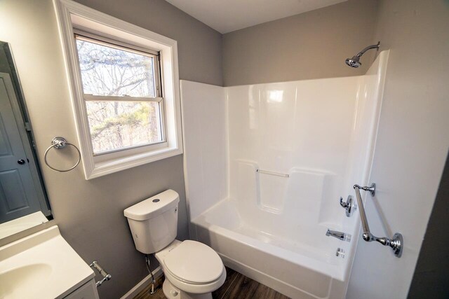 663 Sullivan Trl, Long Pond, PA 18334 - full bathroom featuring toilet, vanity, shower / washtub combination, wood finished floors, and baseboards